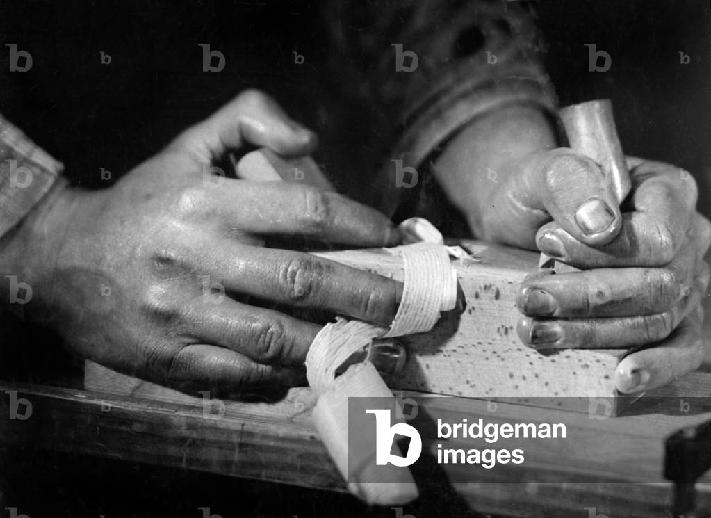 Carpenter planing, 1940 (b/w photo)
