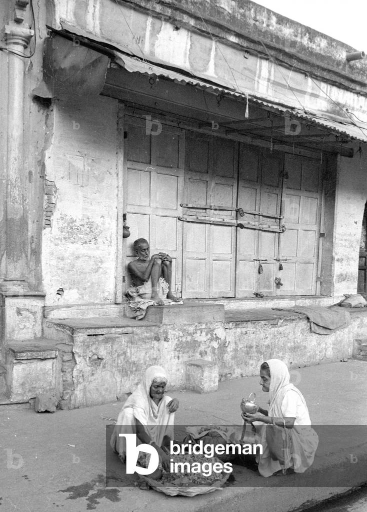 Women eating on the street in Benares, 1966 (b/w photo)