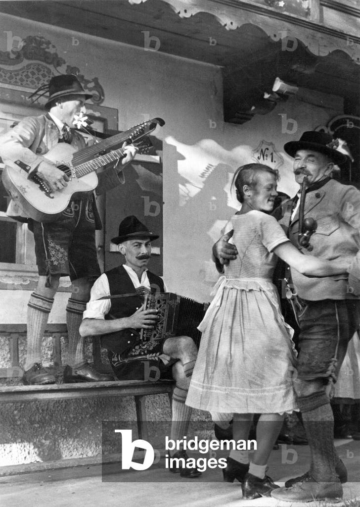 Dancing farmers during the church consecration festival, 1935 (b/w photo)