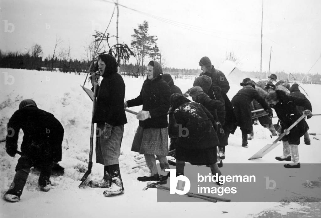 Russian forced laborers clear a runway, 1942 (b/w photo)