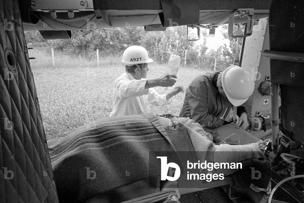A victim is made ready for transport, 1970 (b/w photo)