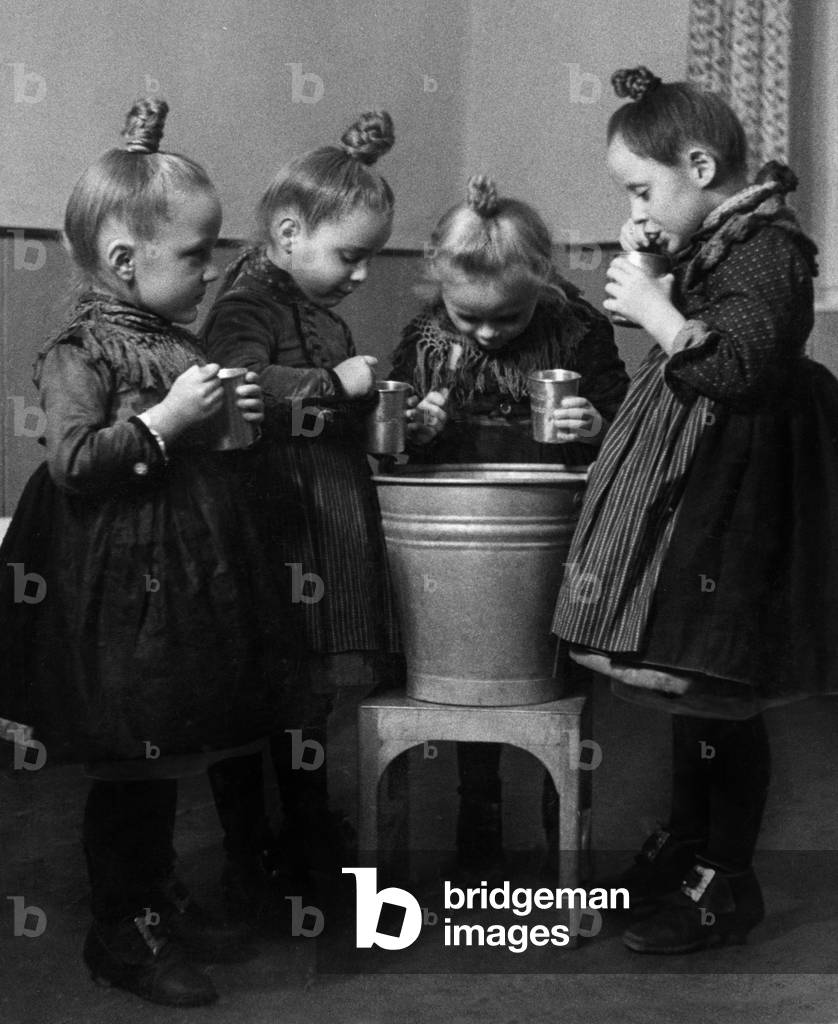 Little girls brushing their teeth (b/w photo)