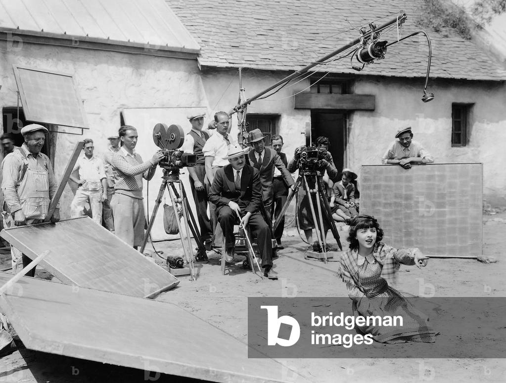 William Seiter and Colleen Moore during filming of 'Smiling Irish Eyes', 1929 (b/w photo)