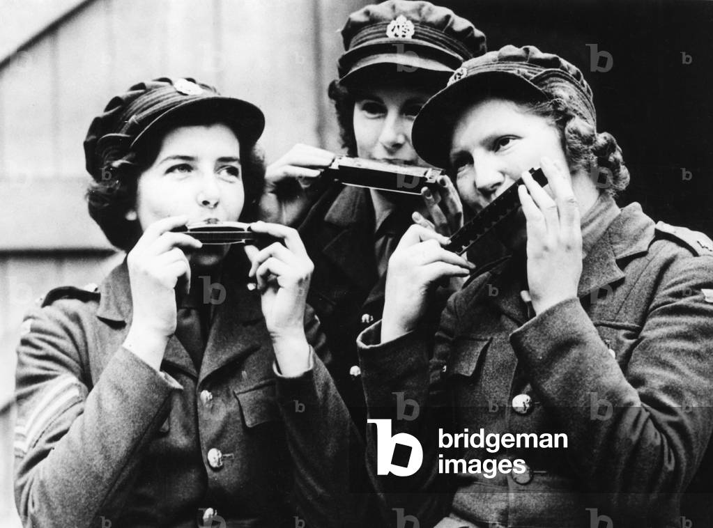 Women of the Auxiliary Territorial Service (ATS) in France playing harmonica, 1939 (b/w photo)