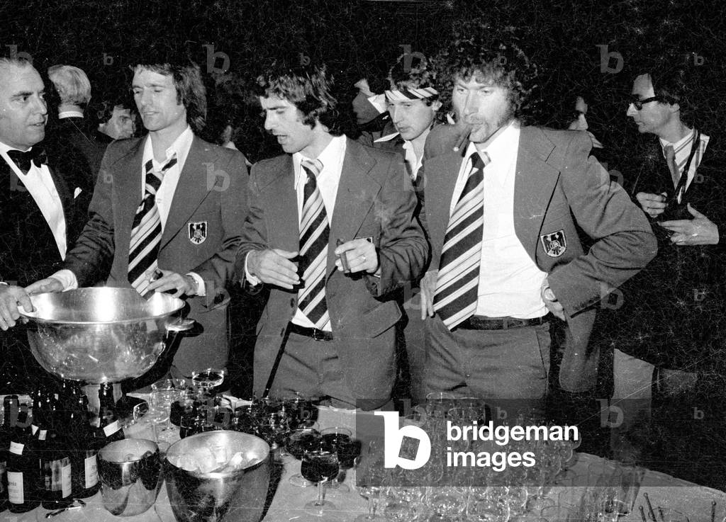 Wolfgang Overath, Gerd Müller and Paul Breitner at the celebration of the World Cup victory in Munich, 1974 (b/w photo)