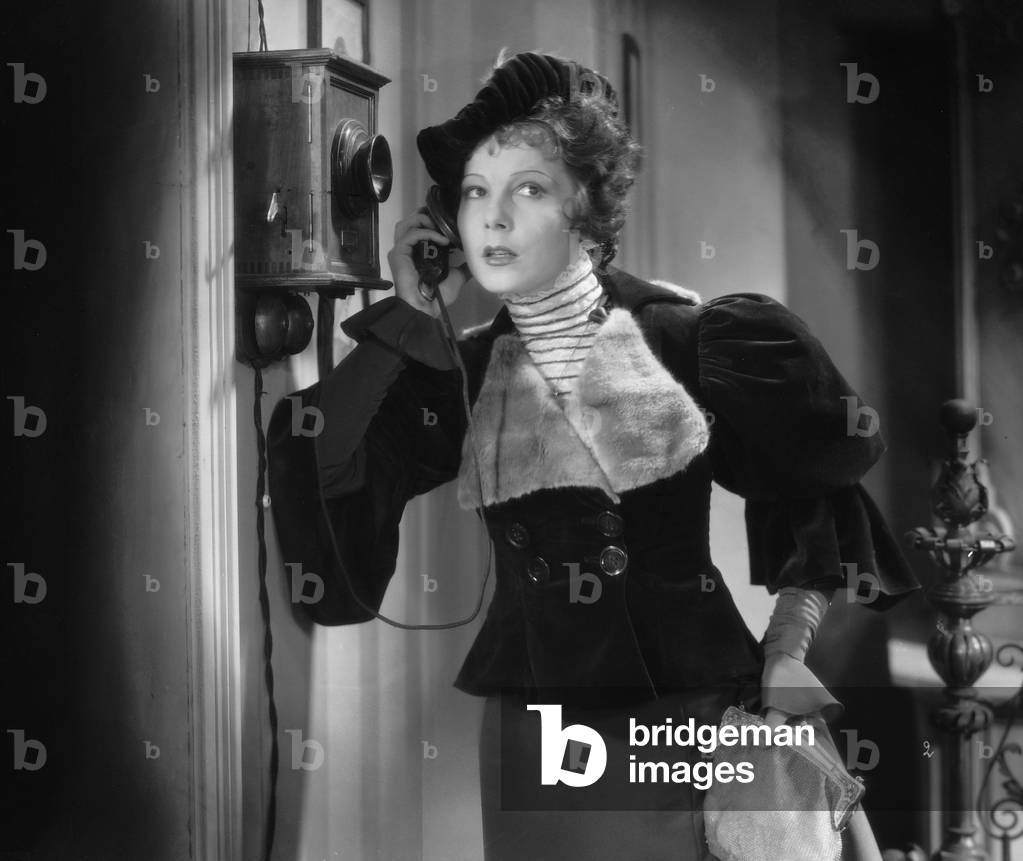 Woman on the wall phone, 1934 (b/w photo)