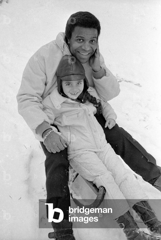 Roberto Blanco with sledge, 1970 (b/w photo)