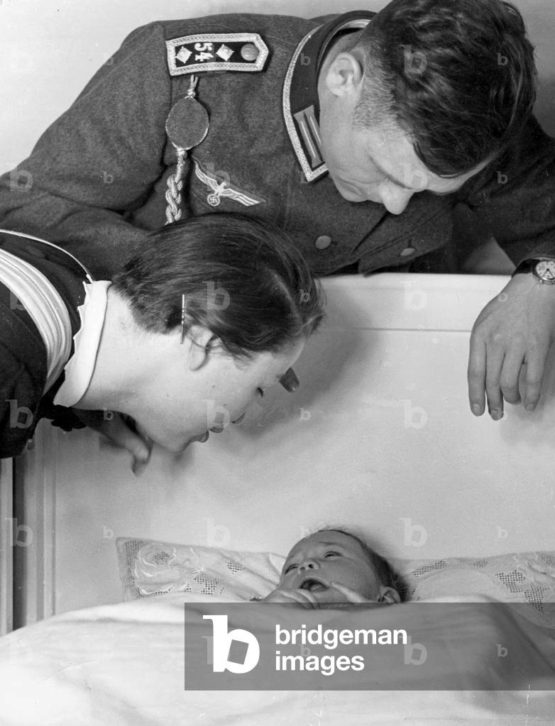 Family with small child, 1939 (b/w photo)