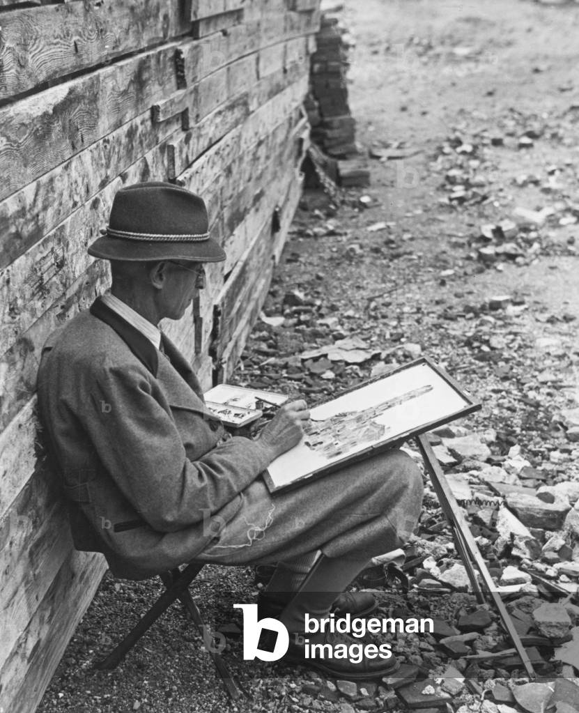 Painter painting in the destroyed Munich, 1945