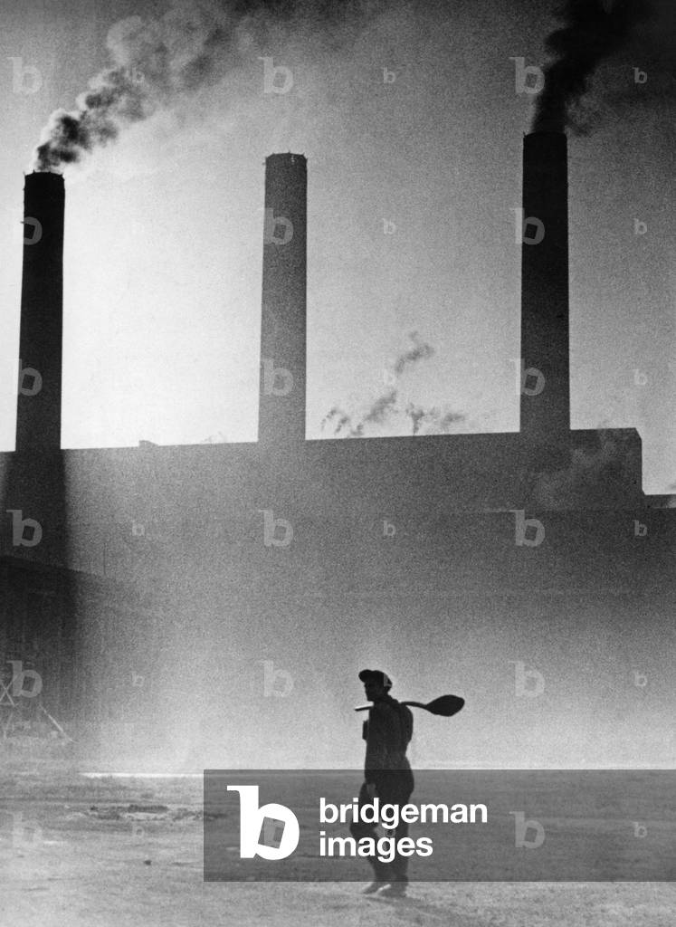 Workers in front of an industrial factory, 1950s (b/w photo)