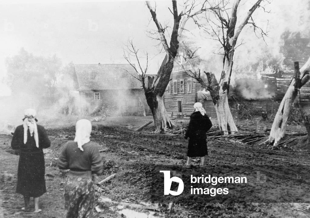 Residents of a burning town on the Eastern Front, 1941 (b/w photo)