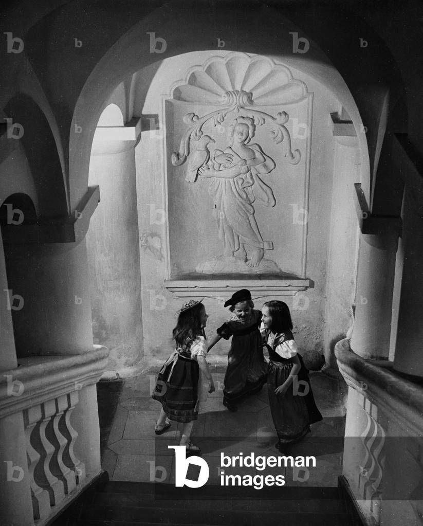 Children playing in a church stairwell (b/w photo)