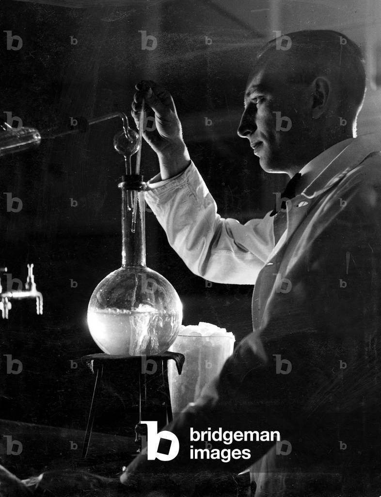 Chemist in an experiment (b/w photo)