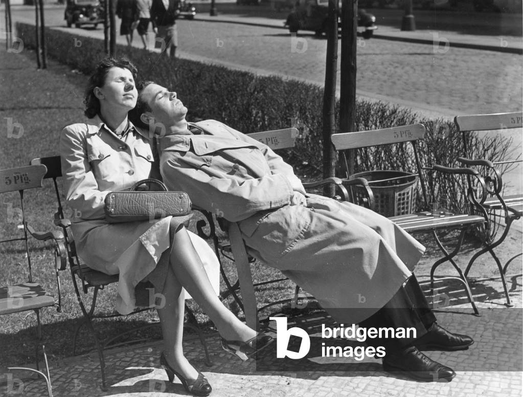 A couple sunbathing in a park, 1940 (b/w photo)
