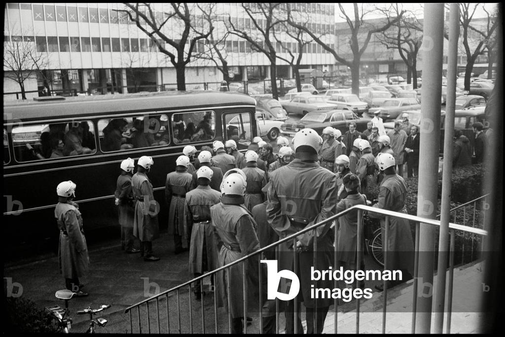 The police escorts students to a bus in Frankfurt, 1969 (b/w photo)