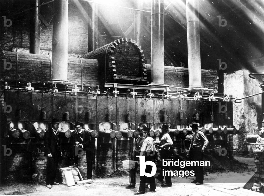 Industrial workers in a zinc smelter, 1899 (b/w photo)