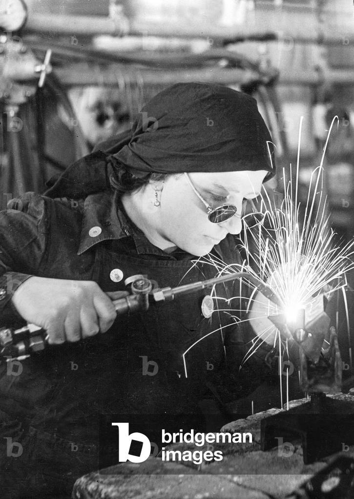 Woman in a German war factory, 1940 (b/w photo)