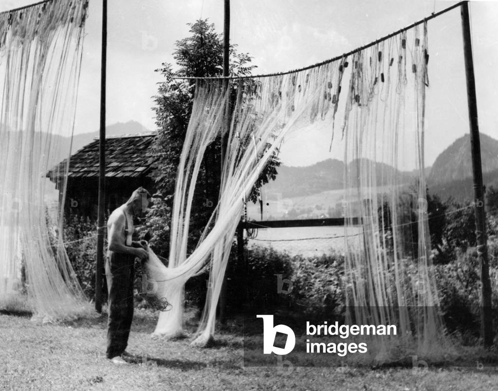 A fisherman on Wolfgangsee in Austria, 1943 (b/w photo)