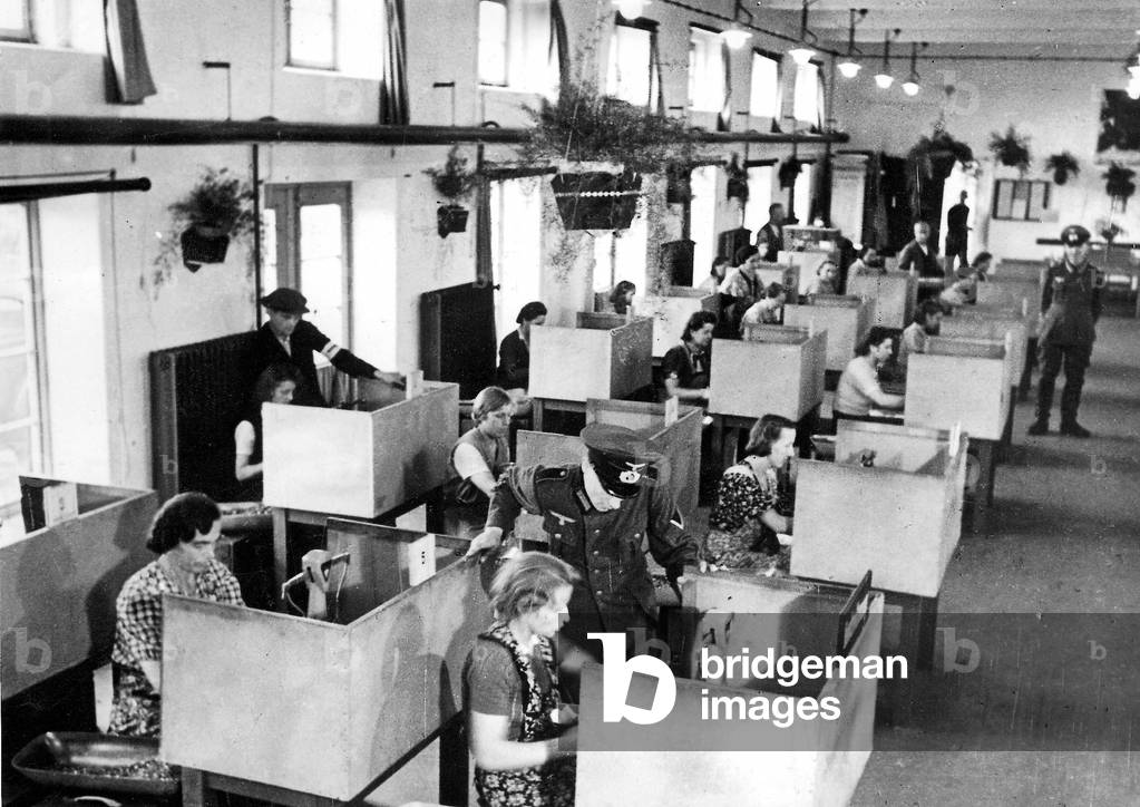Forced laborers in a munitions factory (b/w photo)