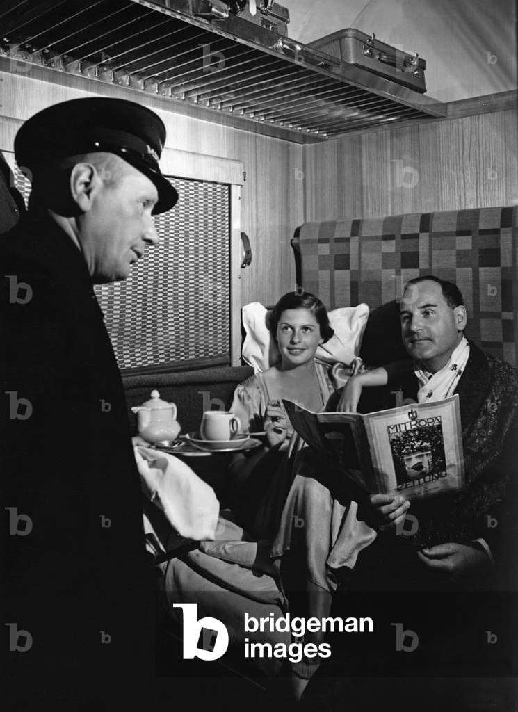 Train passengers, 1935 (b/w photo)