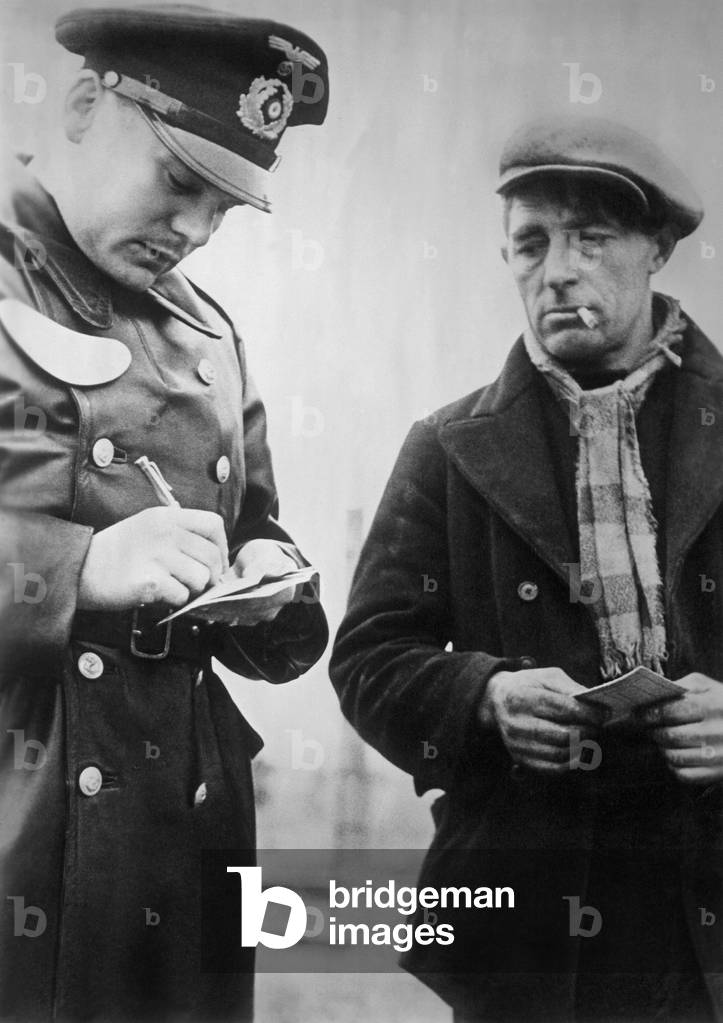 Forced laborers at a passport control in Belgium, 1942 (b/w photo)