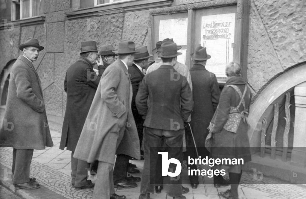 German civilians look at a poster in the occupied Ruhr area, 1923