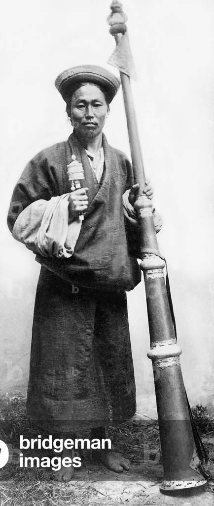 Tibetan monk with a prayer trumpet, 1908 (b/w photo)