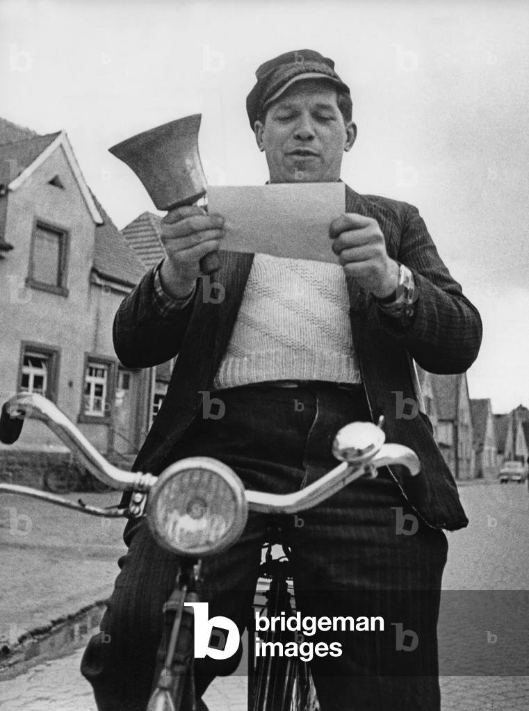 Town crier on his bike (b/w photo)