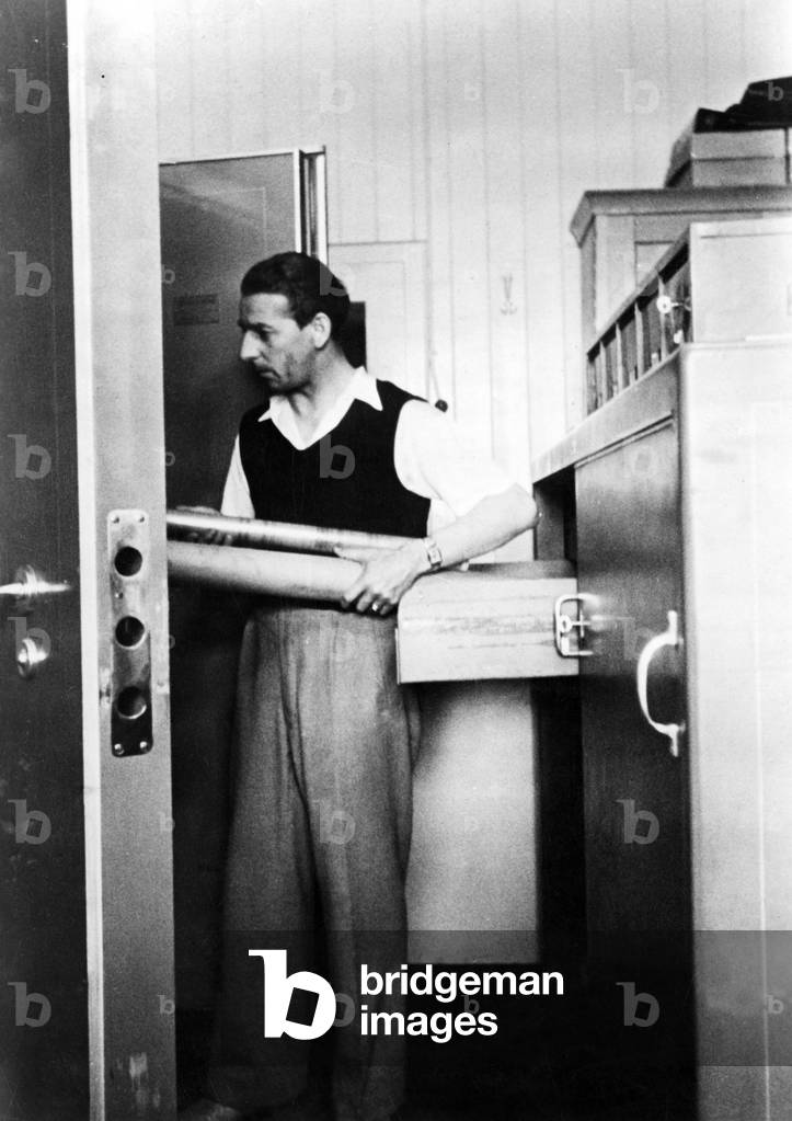 The plans of a new machine are taken out of a cabinet, 1944 (b/w photo)