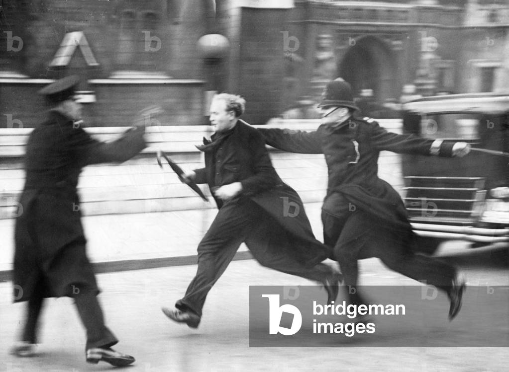 Police chasing a demonstrator in London, 1939 (b/w photo)
