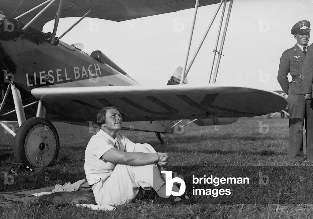 Liesel Bach in front of her airplane, 1936 (b/w photo)