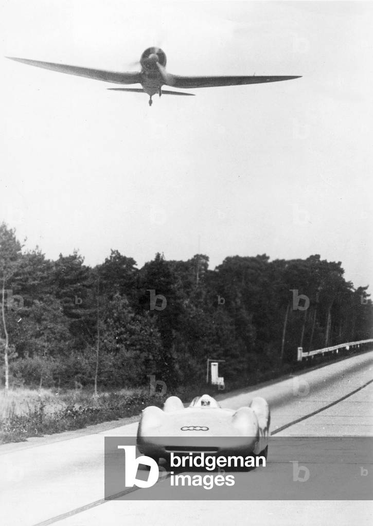 Bernd Rosemeyer in a race with an airplane, 1937 (b/w photo)