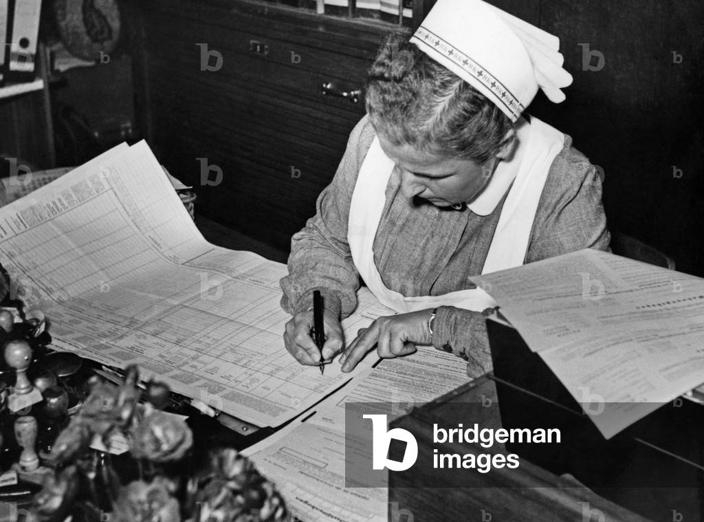 Nurse doing paperwork, 1940s