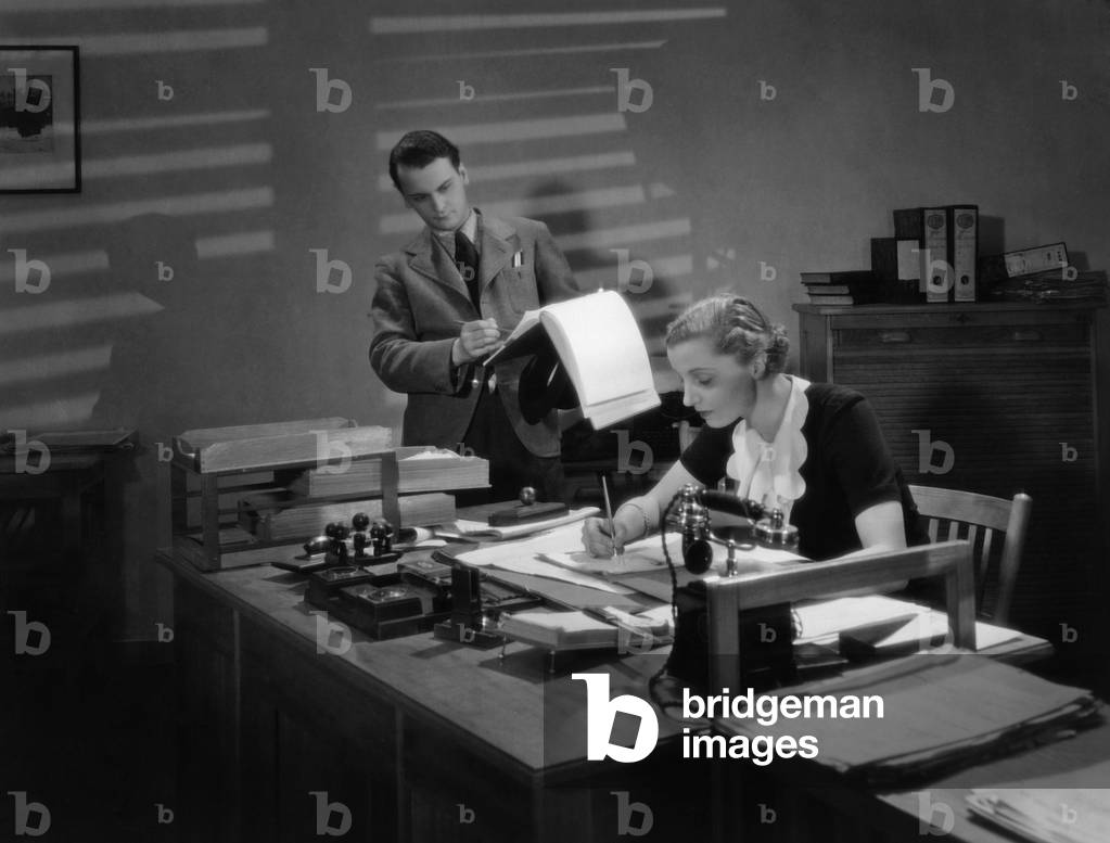 Secretary at the desk, 1936 (b/w photo)