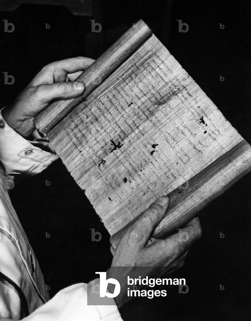 Hugo Ibscher holds a papyrus document in roll form, 1934 (b/w photo)