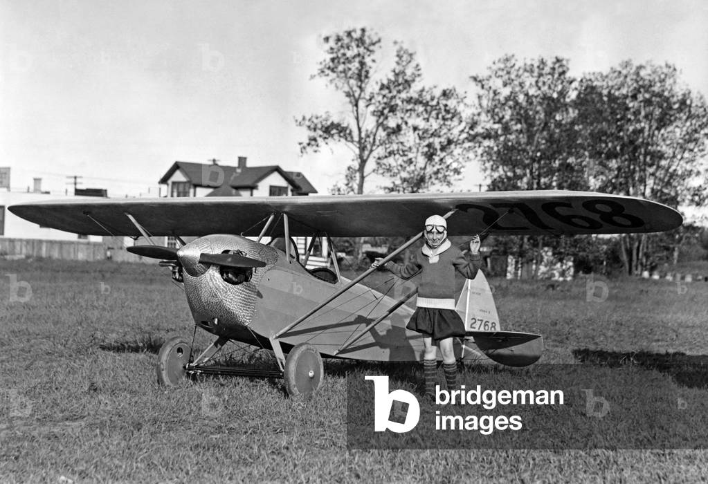 Woman next to a small sports airplane, 1927 (b/w photo)