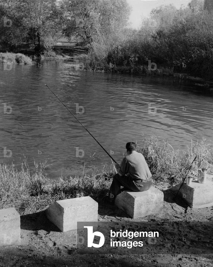 An angler at the lake (b/w photo)