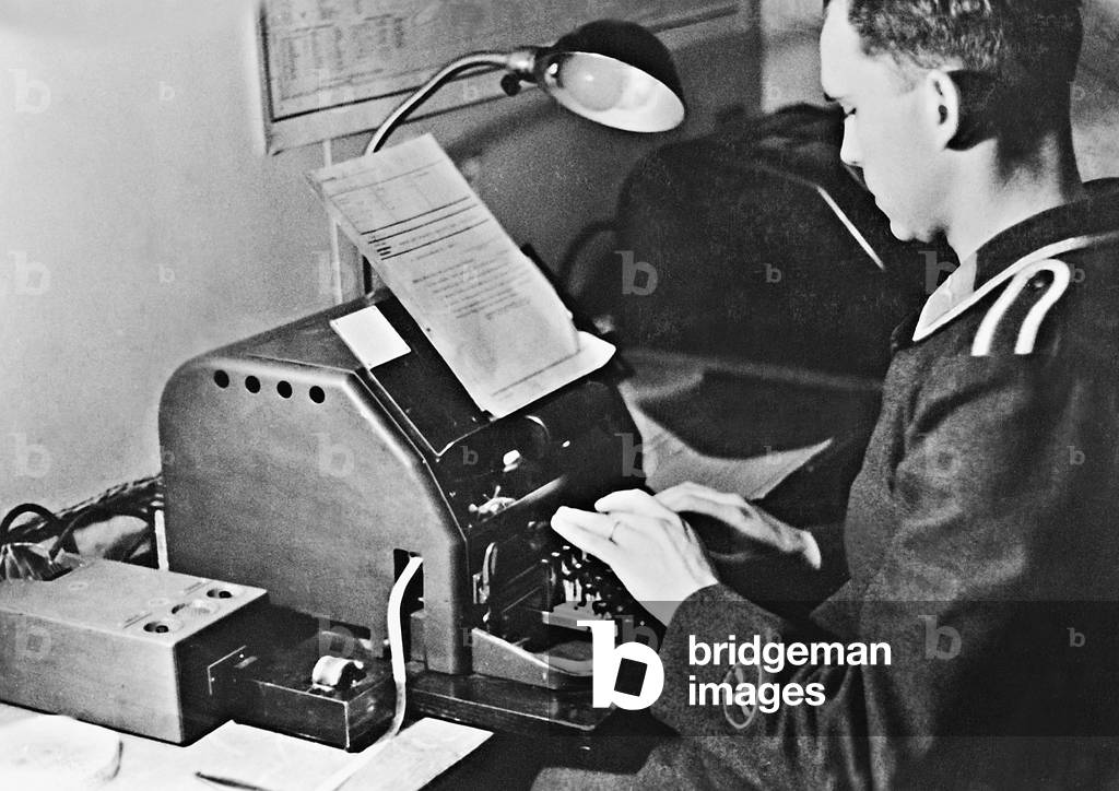Soldier at a telegraph machine on the Eastern front, 1941 (b/w photo)