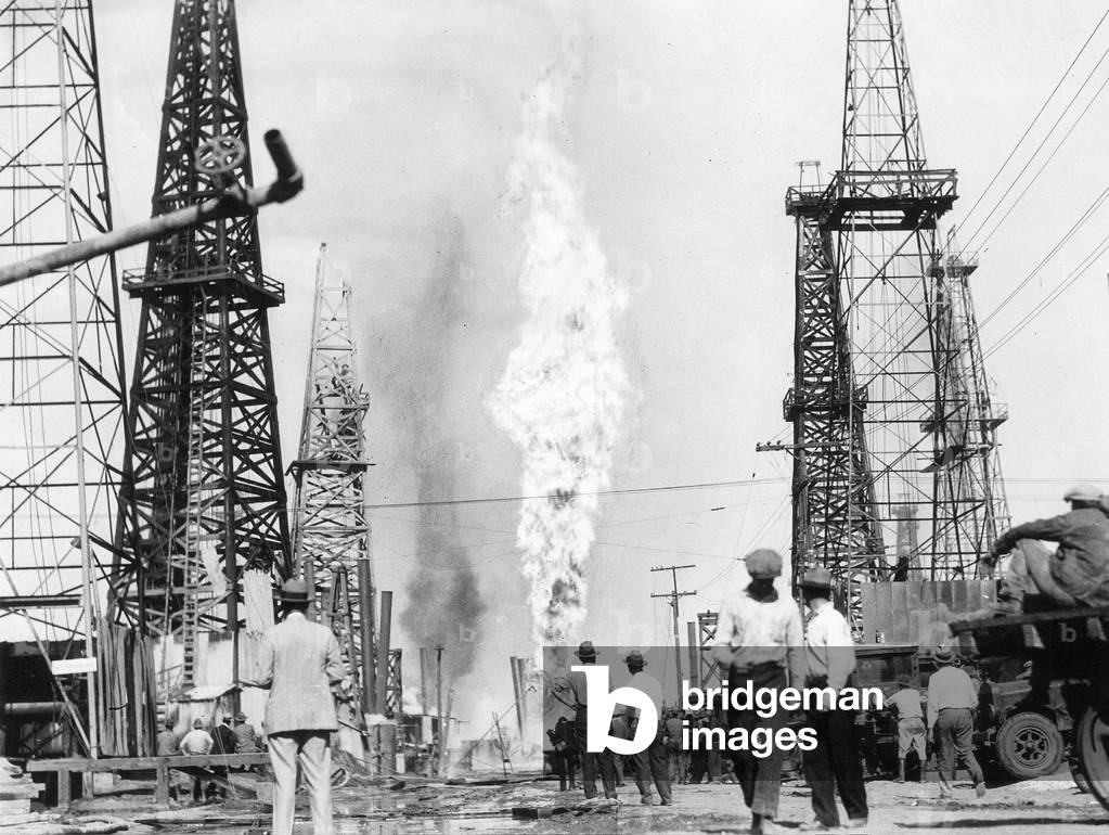 Burning oil well on an American oil field, 1928 (b/w photo)
