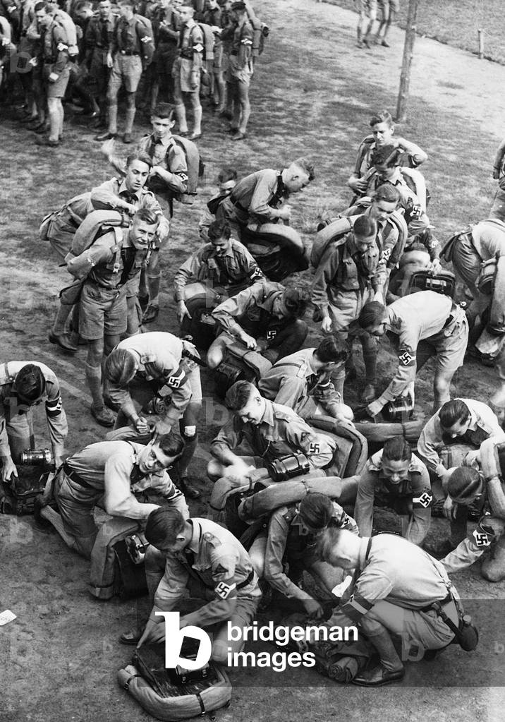 Hitler Youth members pack up their knapsacks, 1937 (b/w photo)