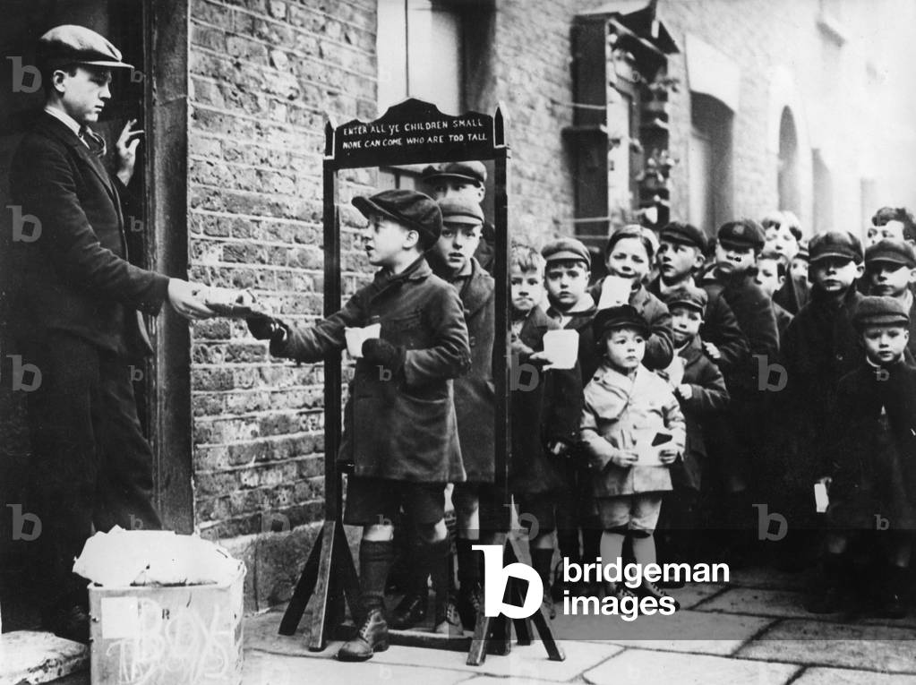 Children receive gifts during the Great Depression in London, 1930s (b/w photo)