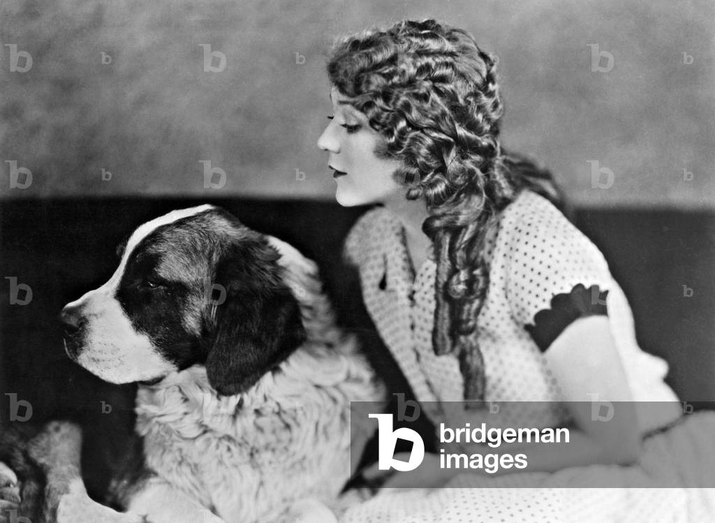 Mary Pickford with a dog, 1928 (b/w photo)