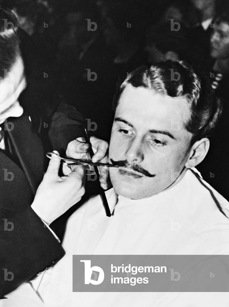 Hairdresser while shaving, 1935 (b/w photo)