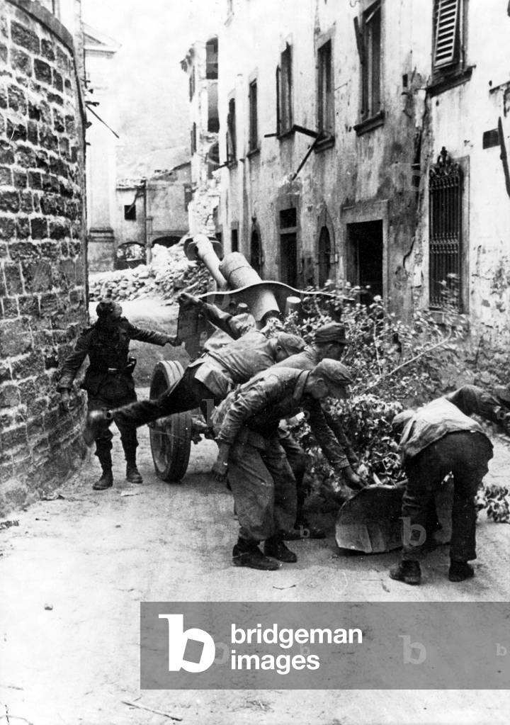 German gun in an Italian town, 1944 (b/w photo)