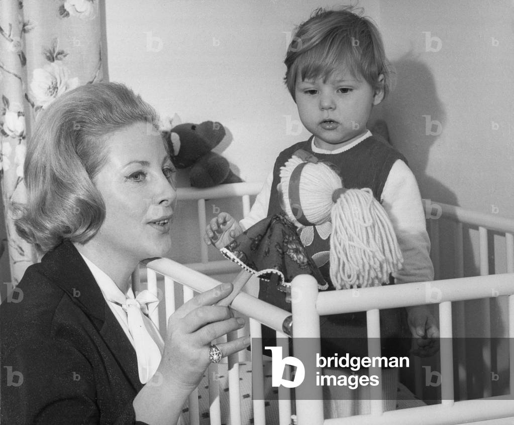 Mother playing with daughter, 1950s (b/w photo)