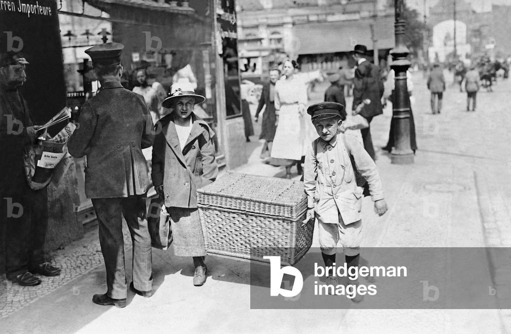 On the way to the railway station with a travel basket (b/w photo)