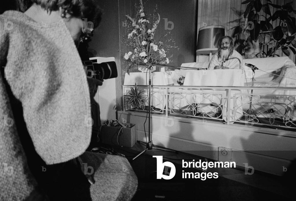 Maharishi Mahesh Yogi at a press conference (b/w photo)
