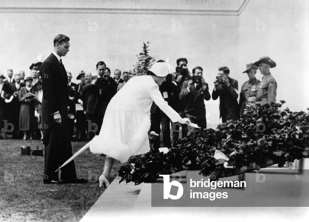Queen Elizabeth and King George VI in front of a monument to the fallen in France, 1938 (b/w photo)