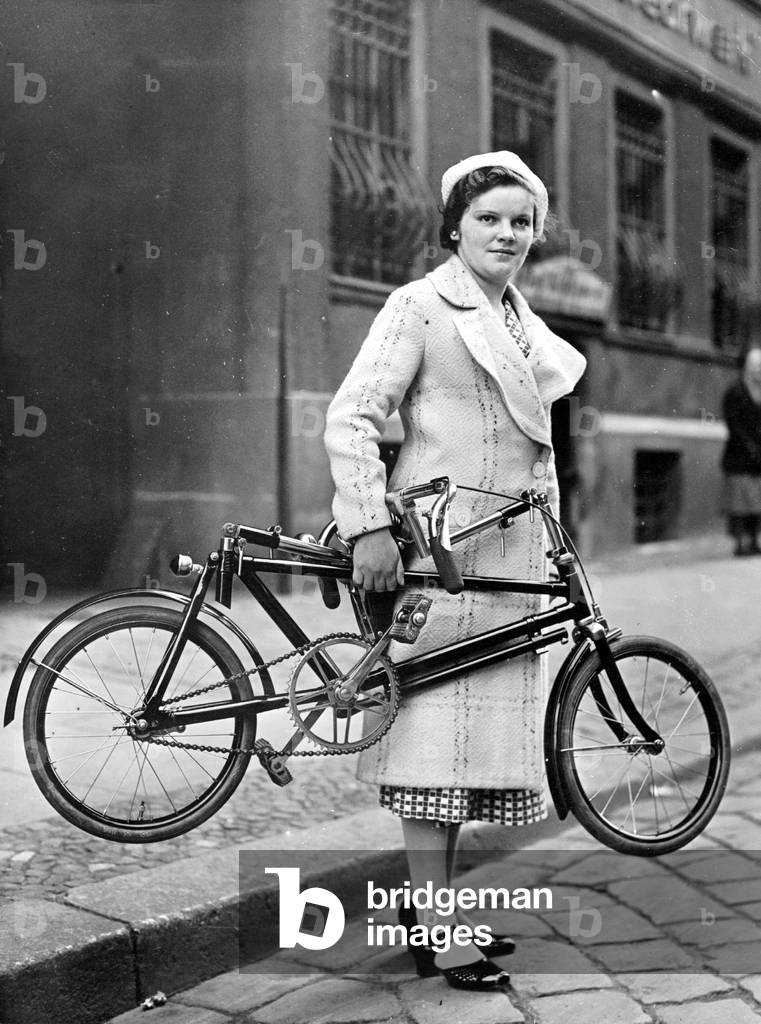Woman with a folding bike, 1936 (b/w photo)
