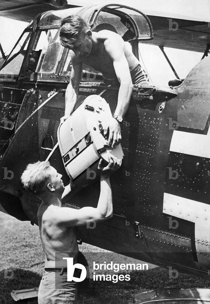 Removal of a camera from a German reconnaissance plane, 1941 (b/w photo)